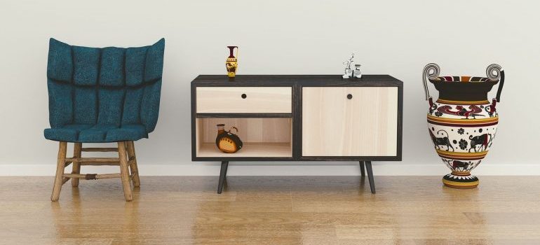 A chair, a vase, and an end table to be relocated by GTA movers.