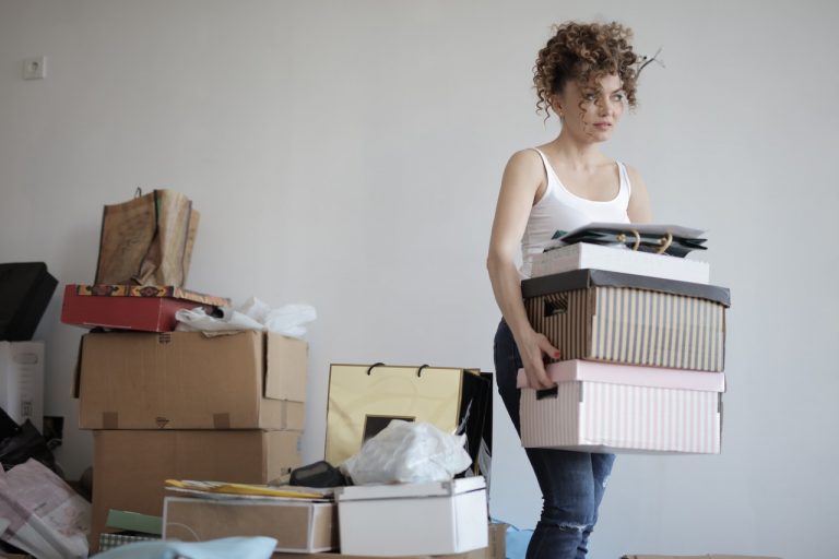 a girl carrying boxes