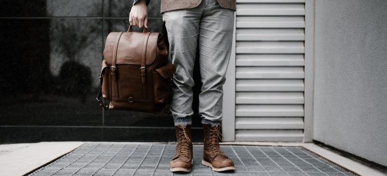 person holding a traveling bag