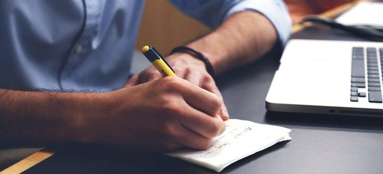 a man writting on paper 