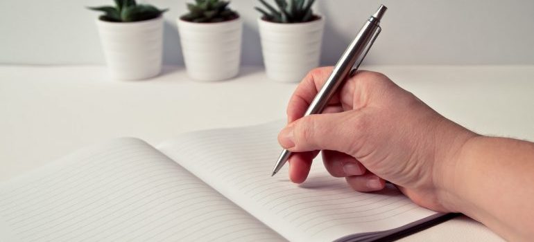 A person writing in a notebook.