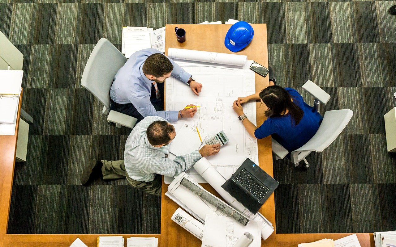 Employers gathered around an office table