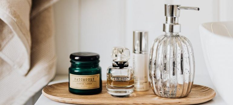 Cosmetics glass bottles on a wooden tray