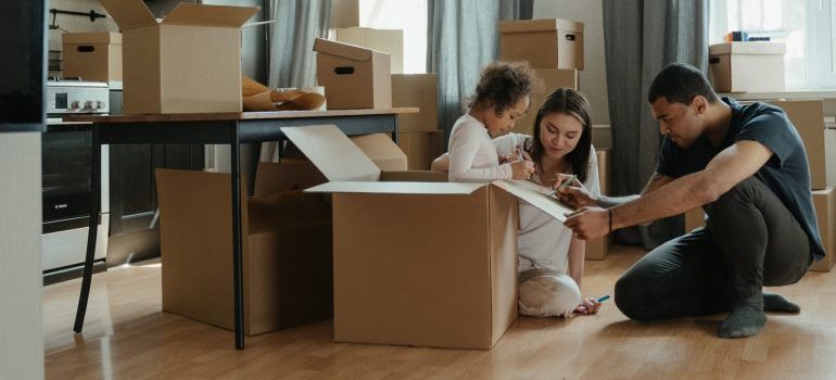 A family packing up their boxes to relocate to Aurora
