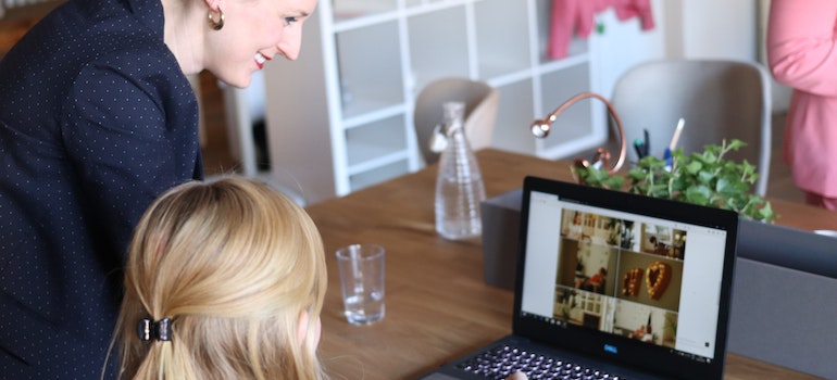 Two women in an ofiice looking at a laptop