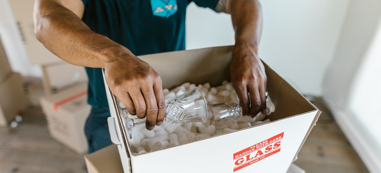 a man packing glass items