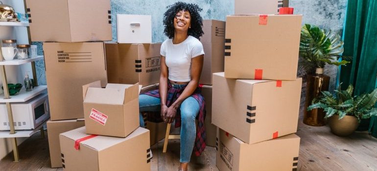 Woman sitting next to the boxes