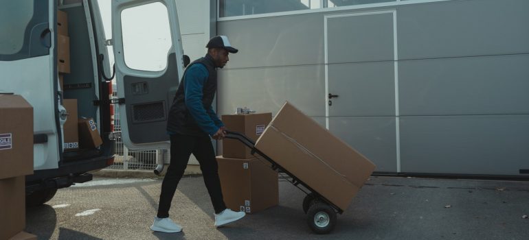 Man using a dolly as one of the tools that will make your Aurora move easier