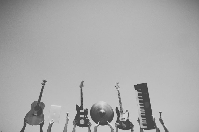 people holding different musical instruments high above their heads