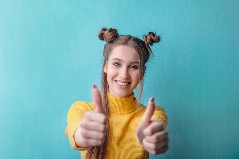 a happy woman showing thumbs up