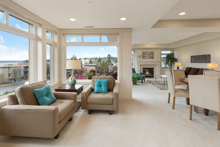 Spacious and tidy house with sofas, fireplace, and a few decorations.