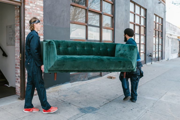 professional movers carrying a couch