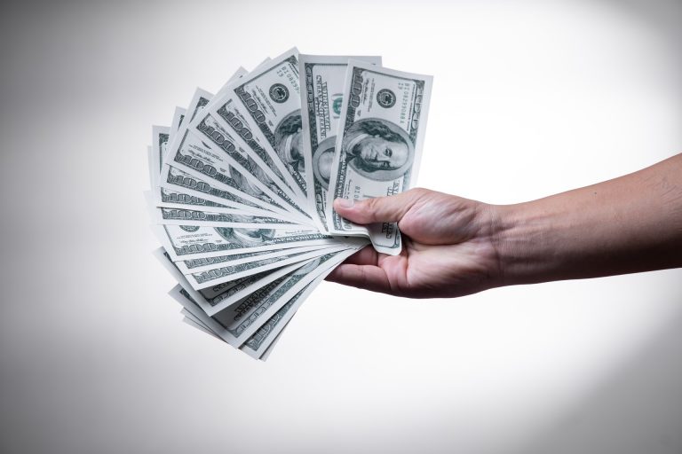 A man holding paper bills