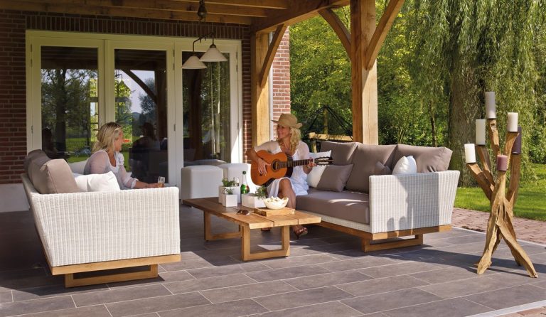 Two women sitting on some outdoor furniture