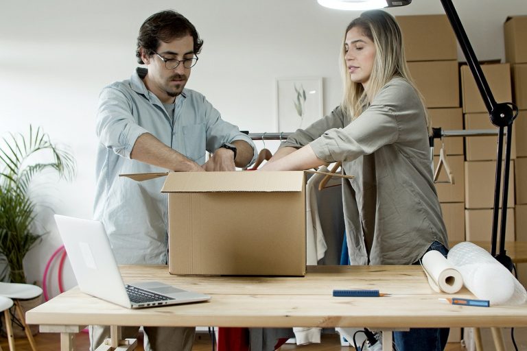 Couple packing a box together