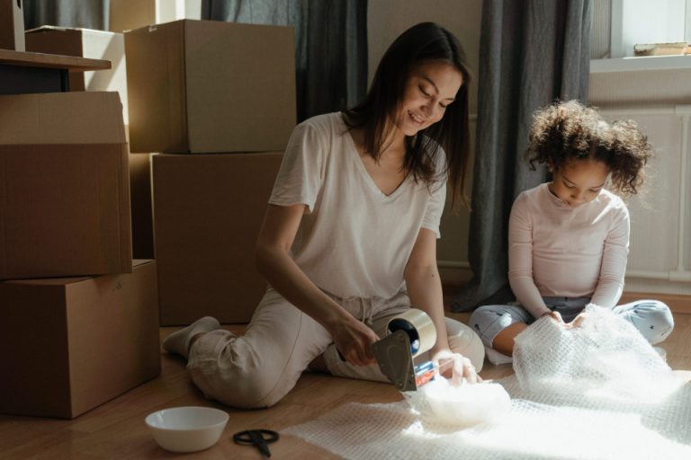 A woman and a little girl packing things for the move