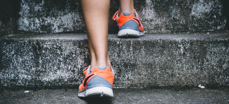 a woman jogging in order to cope with moving depression after relocating to Canada