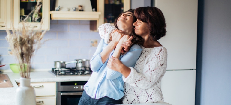 mother and daughter hugging each other