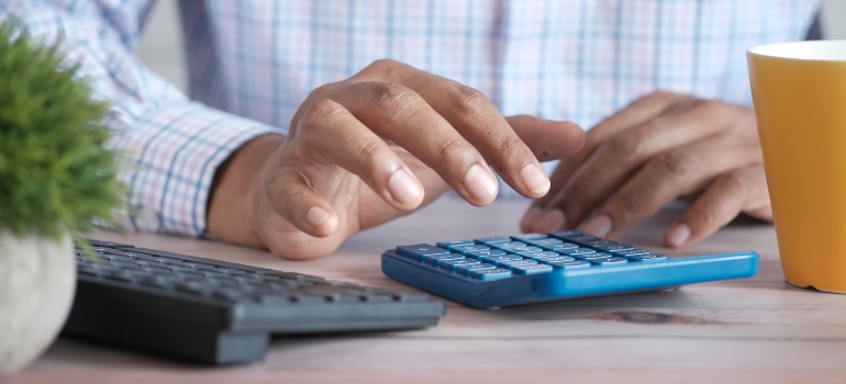 a man calculating a budget for moving from a condo to a large house
