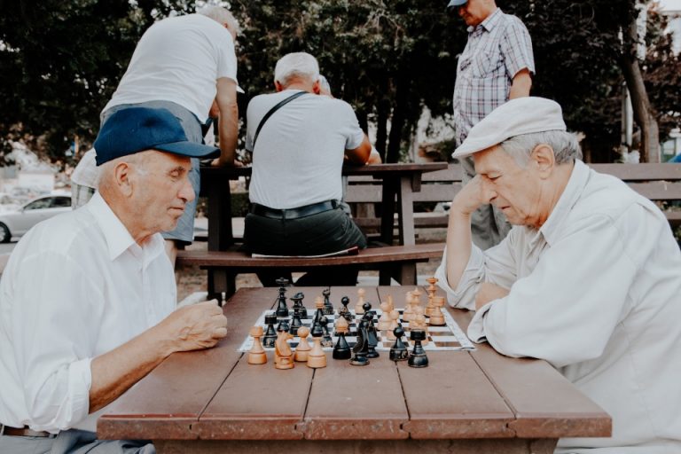 Elderly people playing chess in the park