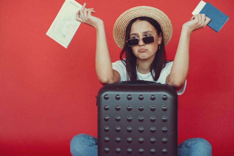 A woman with a packed suitcase and documents wondering whether to choose Odessa or Prescott ON