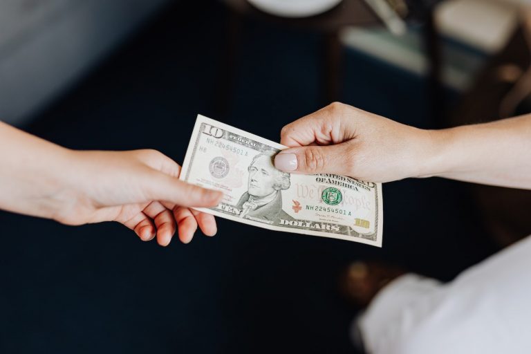 A person giving a tip to their mover