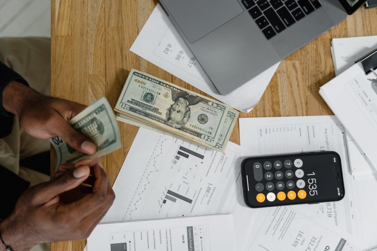 Person calculating the cost of moving with a calculator
