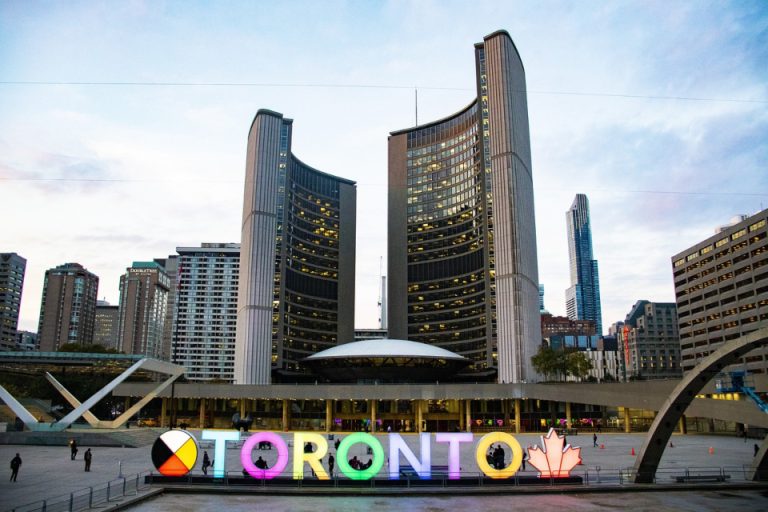 Toronto sign in front of the buildings