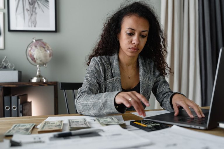 A person calculating the cost of living in Prescott vs. Belleville