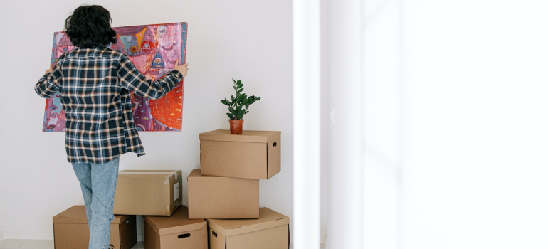 A girl who prepares a valuable painting for moving
