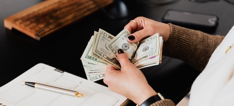 A girl counting money after reading about small town real estate trends to watch in Canada