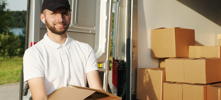 A mover next to a moving truck
