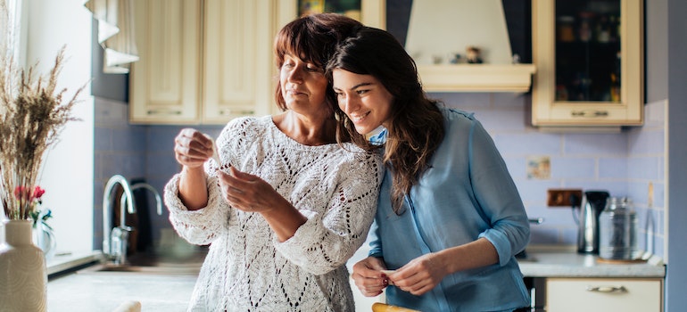A mother and daughter making cookies in a kitchen