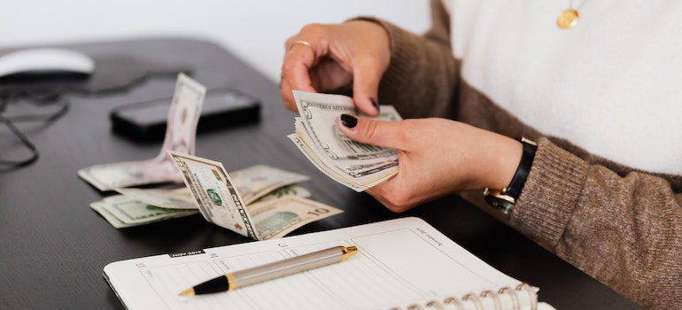 a woman counting money in budget for a stress-free move from Burlington to Bradford