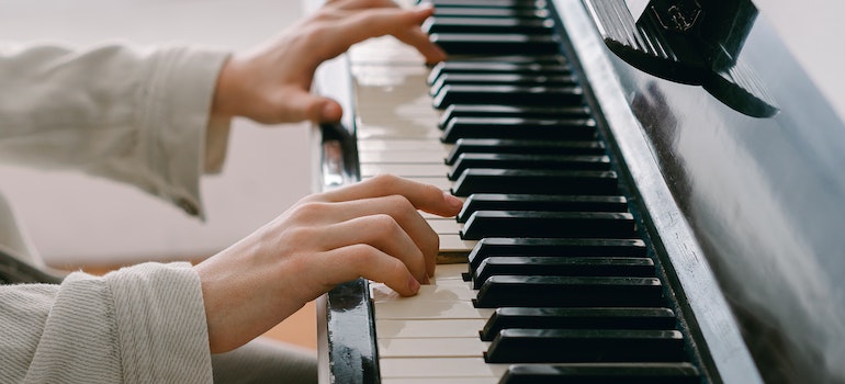 A person playing the piano and thinking about how to prepare a piano for a move