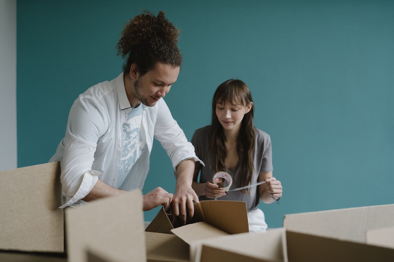 A couple packing for a summer move in Canada