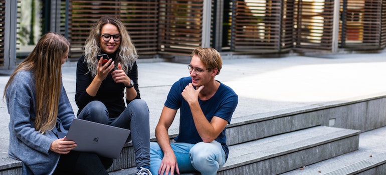 Students talking in front of a college