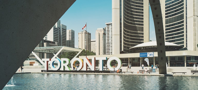 Toronto sign in front of the buildings