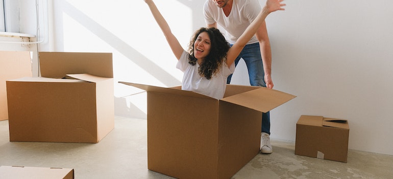 A couple with moving boxes preparing for a move