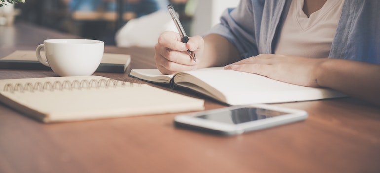 A person writing in a notebook