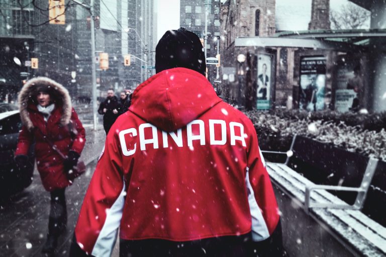 A man with Canada jacket in one of the Canada cities for teenagers