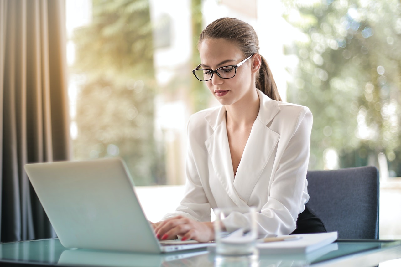 A woman working and using her laptop after finding a job in Brampton