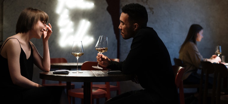 A couple enjoying dinner in a restaurant in one of the romantic spots in Canada