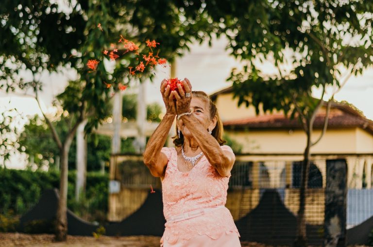 A woman in a pink dress happy after her move to Richmond Hill as a senior
