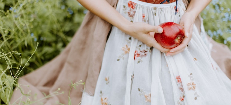 A girl holding an apple