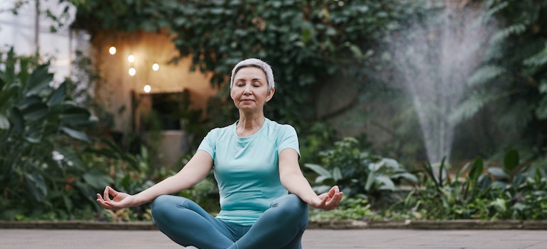An elderly woman meditating
