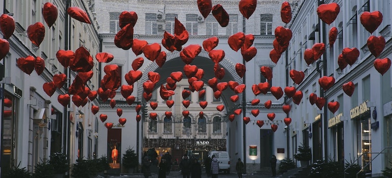 A lot of floating hearts in a city