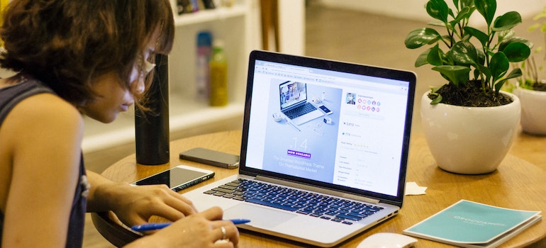 A woman looking at a laptop while trying to find a job in Brampton