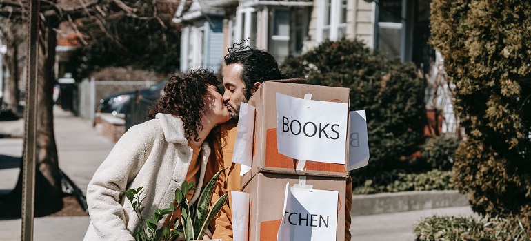 people carrying moving boxes