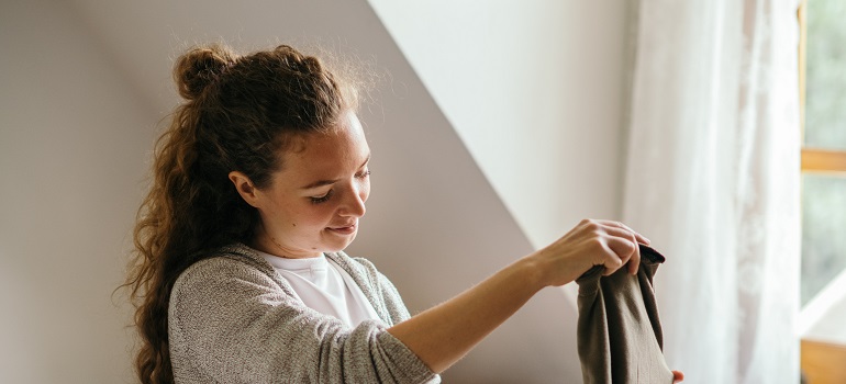 a girl packing her items when downsizing in Toronto